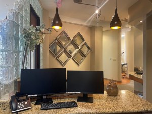 Inside of office behind front desk with computers
